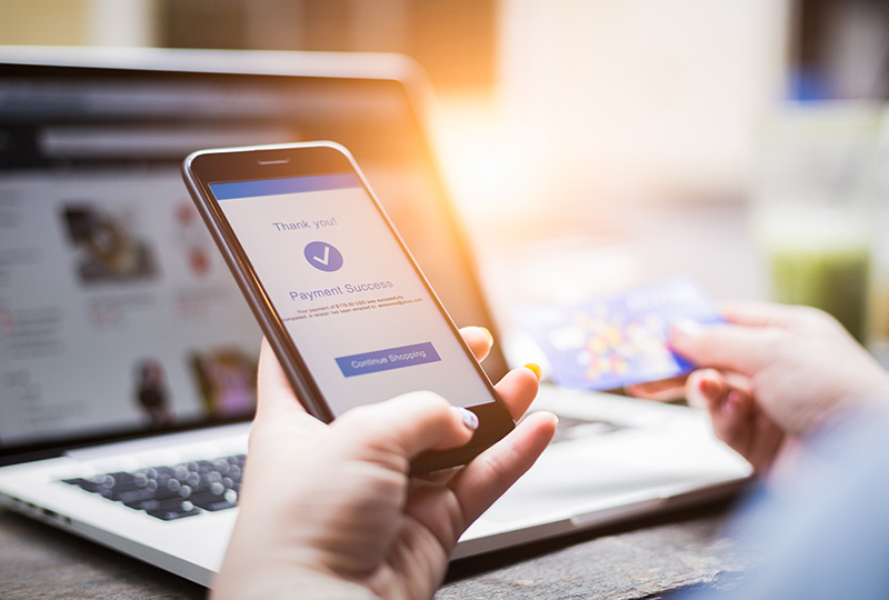 A woman sitting at a desk in an office, working on a computer.